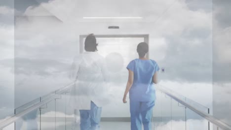 Animation-of-clouds-and-sky-over-doctors-running-in-hospital