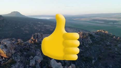 Animation-of-thumbs-up-yellow-icon-over-landscape