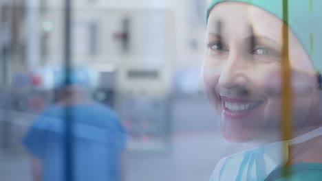 Portrait-of-caucasian-female-surgeon-smiling-at-hospital-against-city-traffic-at-hospital