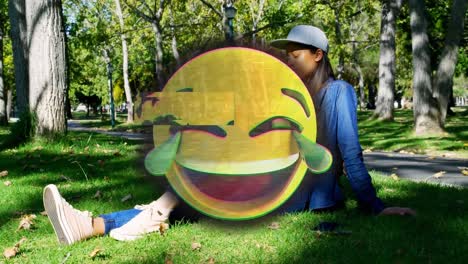 Animation-of-happy-emoji-over-woman-outdoors