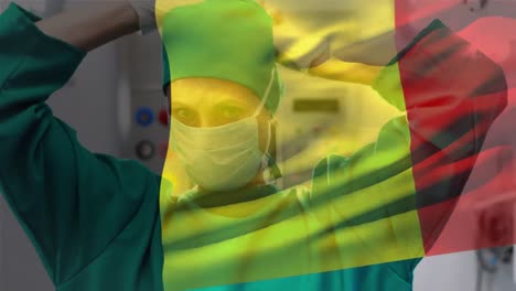 Digitale-Komposition-Einer-Belgischen-Flagge,-Die-Im-Krankenhaus-Gegen-Eine-Chirurgin-Mit-Gesichtsmaske-Winkt