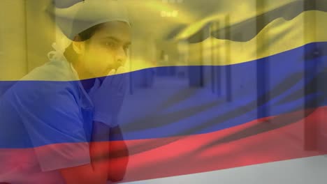 Digital-composition-of-colombia-flag-waving-over-stressed-caucasian-male-health-worker-at-hospital