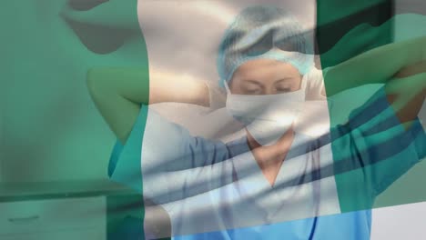 Digital-composition-of-nigeria-flag-waving-over-female-health-worker-wearing-face-mask-at-hospital