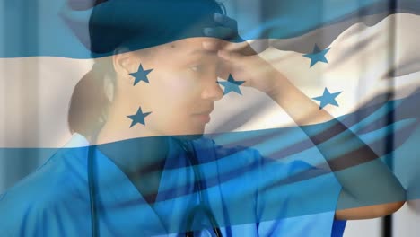 Honduras-flag-waving-against-stressed-african-american-female-health-worker-at-hospital