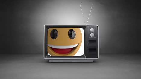 Digital-animation-of-smiling-face-emoji-on-television-screen-against-grey-background