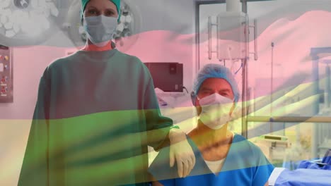 Animation-of-flag-of-germany-waving-over-surgeons-in-face-masks
