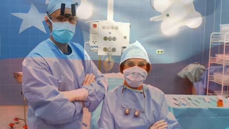 Animation-of-flag-of-chile-waving-over-surgeons-in-face-masks
