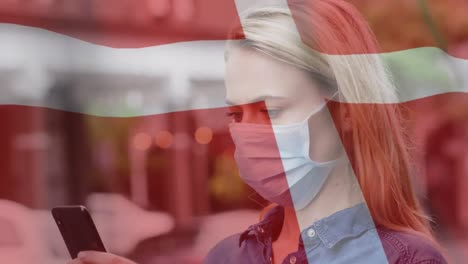 Animation-of-flag-of-denmark-waving-over-woman-in-face-masks