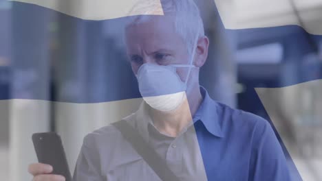 Animation-Der-Flagge-Finnlands,-Die-über-Einem-Mann-Mit-Gesichtsmasken-Weht