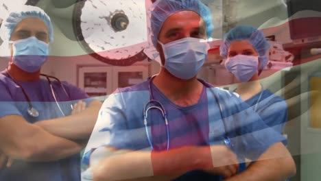 Animation-of-flag-of-england-waving-over-surgeons-in-face-masks