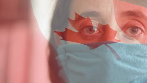 Animation-of-flag-of-canada-waving-over-woman-in-face-masks