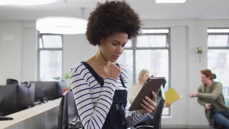 Portrait-of-african-american-creative-businesswoman-using-tablet-in-modern-office