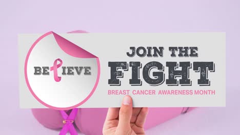 Animation-of-pink-ribbon-logo-with-breast-cancer-text-over-boxing-gloves