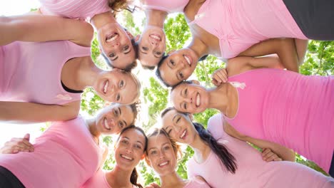 Portrait-of-diverse-group-of-smiling-women-outdoors-in-the-sun-from-below