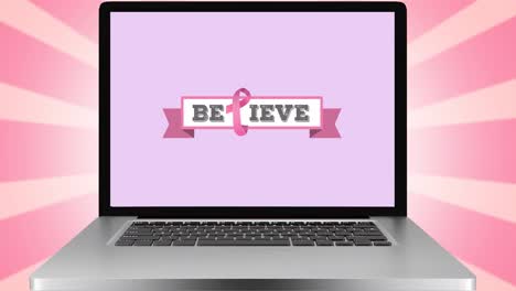 Animation-of-pink-ribbon-logo-and-believe-text-on-laptop-screen