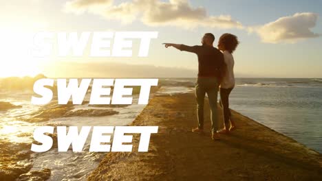 Animation-of-sweet-text-over-couple-on-the-beach