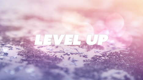 Animation-of-level-up-text-over-ground-cover-with-snow