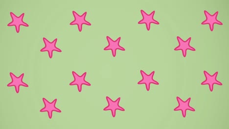 Animation-of-pink-starfish-spinning-on-green-background