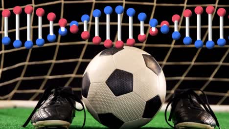 Animation-of-dna-strand-spinning-over-soccer-ball-and-shoes