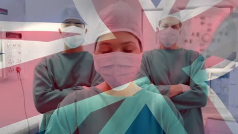 Animation-of-uk-flag-over-group-of-doctors-wearing-face-masks