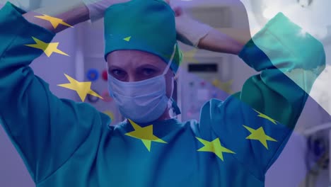 Animation-of-eu-flag-over-female-doctor-wearing-face-mask