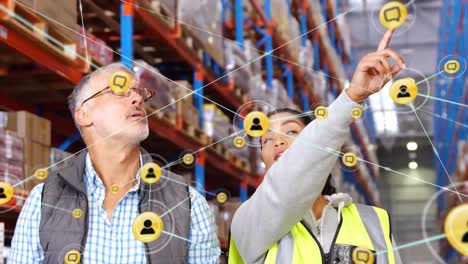 Animation-of-networks-of-connections-with-icons-over-people-working-in-warehouse