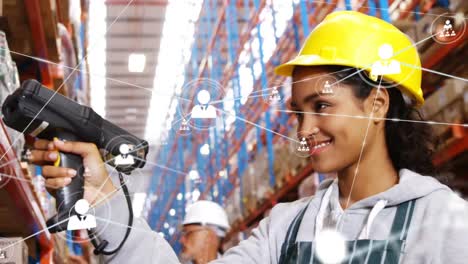 Animation-of-networks-of-connections-with-icons-over-woman-working-in-warehouse