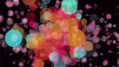 Animation-of-colourful-bokeh-circles-of-light-floating-on-black-background