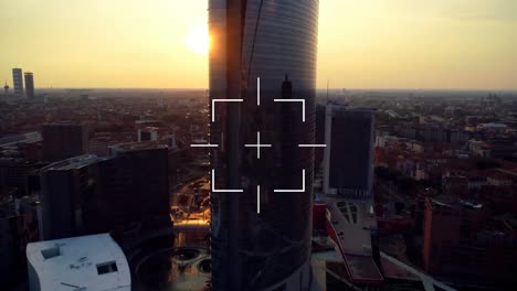 Animation-of-square-scope-scanning-over-modern-cityscape-at-sunset
