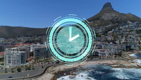 Animation-of-rotating-hands-on-clock-over-mountain-and-modern-coastal-town
