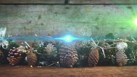 Animation-of-glowing-lights-moving-over-fir-tree-cones-christmas-decorations