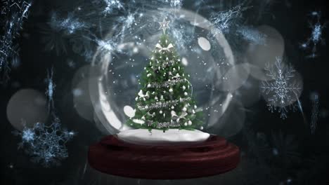 Animation-of-decorated-christmas-tree-in-snow-globe,-with-falling-snowflakes-and-lights,-on-black