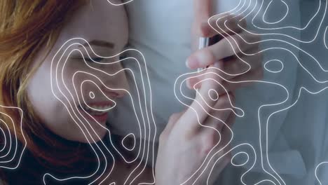 Animation-of-white-lines-over-woman-using-smartphone
