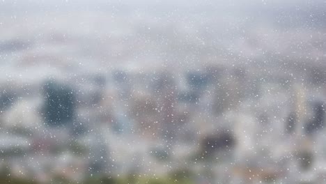 Animation-of-snow-falling-over-out-of-focus-cityscape-in-background