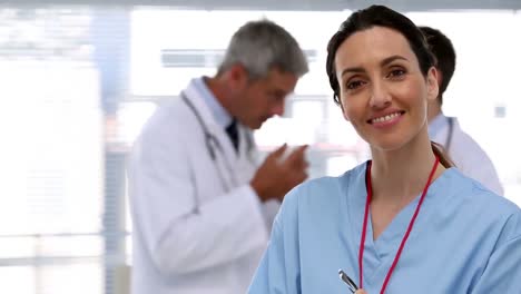 Smiling-nurse-holding-clipboard