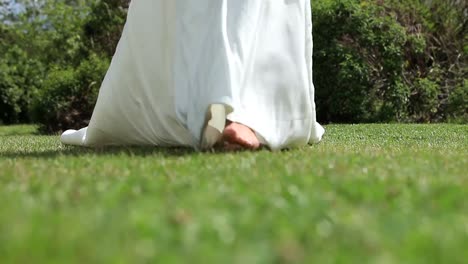 Bride-in-wedding-dress-walking-on-grass