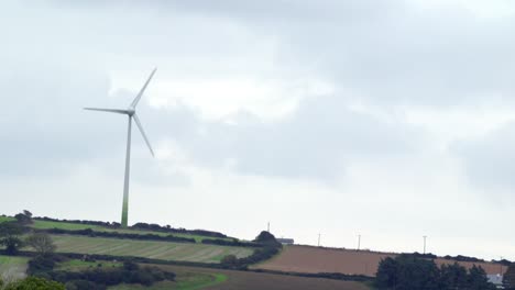 Wind-turbine-revolving-over-farmland