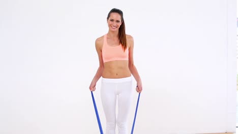 Fit-model-standing-and-stretching-resistance-band