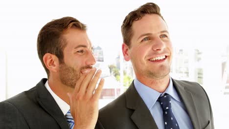 Smiling-businessmen-chatting-together