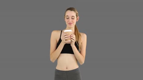 Fit-model-drinking-from-disposable-cup