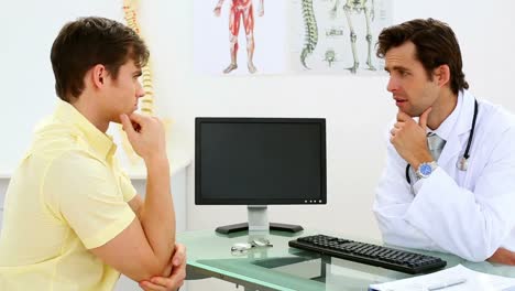 Doctor-speaking-with-his-patient-with-elbow-pain