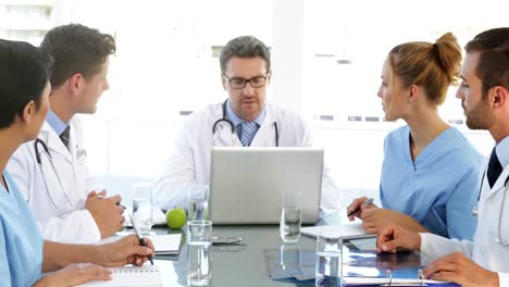 Doctor-talking-with-his-staff-during-a-meeting