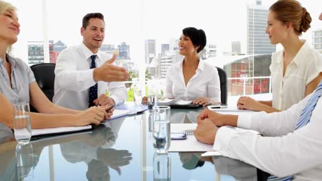 Happy-business-people-shaking-hands-during-meeting