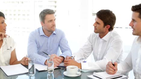 Happy-business-team-chatting-during-meeting