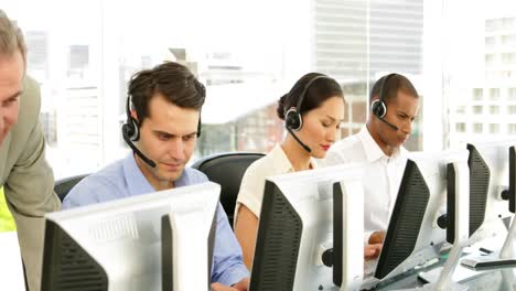 Manager-checking-on-call-centre-employees