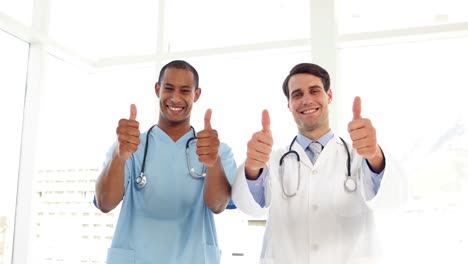Happy-surgeon-and-doctor-giving-thumbs-up