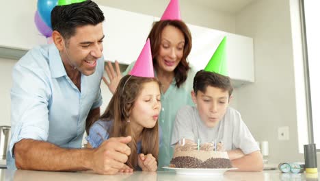 Father-lighting-candles-on-birthday-cake-for-his-son