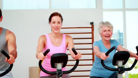 Happy-diverse-fitness-group-doing-a-spinning-class