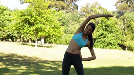 Gorgeous-fit-brunette-stretching-in-the-park