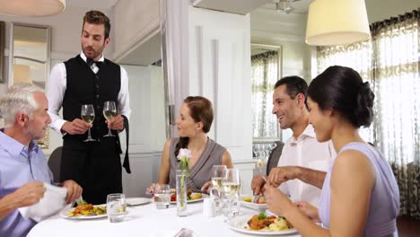Waiter-attending-to-a-table-of-friends